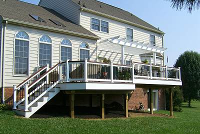 Photo of  a Custom Trex patio deck that includes screened-in gazebo, white railings
and skirt and composite decking